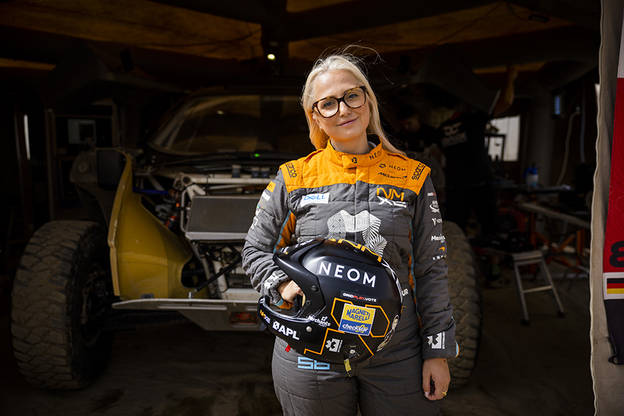 Tamara Molinaro con casco in mano davanti al box del suo SUV Extreme E 2023