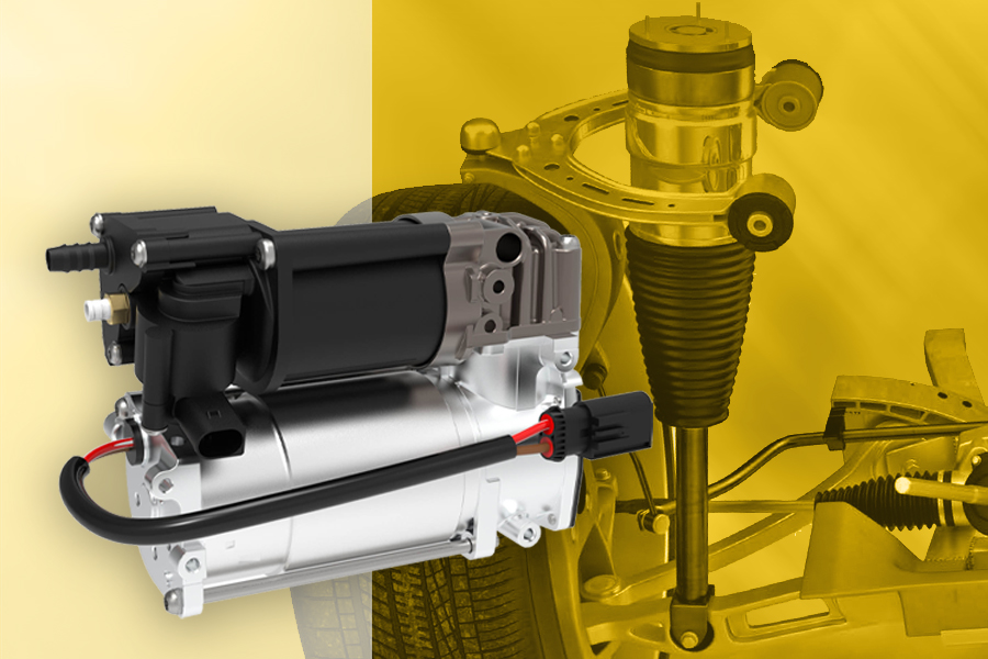 Compressore per sospensioni pneumatiche Magneti Marelli Parts & Services in primo piano, con ruota, asse e sistema di sospensione ad aria sullo sfondo a contestualizzare l’applicazione del componente