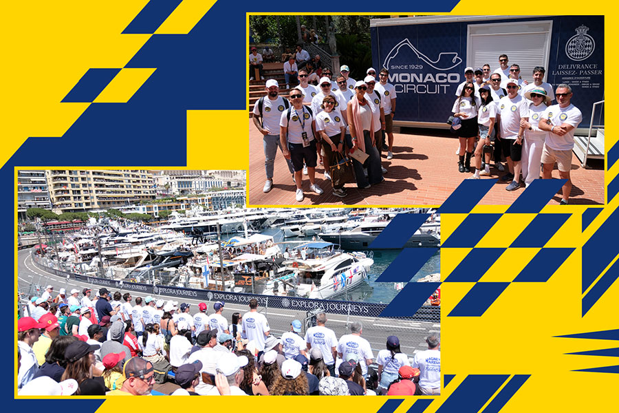 Clienti e partner Magneti Marelli Parts & Services al Gran Premio di Monaco di Formula 1: foto di gruppo nell'area Monaco Circuit e partecipanti in tribuna con vista sul circuito e sul porto.